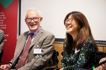Charles Goodhart and Kathy Yuan laughing